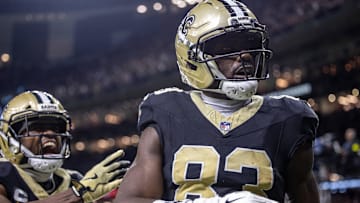 Sep 14, 2025; New Orleans, Louisiana, USA;  New Orleans Saints tight end Juwan Johnson (83) reacts to catching a touchdown against San Francisco 49ers safety Marques Sigle (36) during the first half at Caesars Superdome.