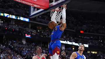 May 3, 2025; Denver, Colorado, USA; Denver Nuggets guard Russell Westbrook (4) finishes off a basket over LA Clippers guard Bogdan Bogdanovic (10) in the second quarter during game seven of first round for the 2025 NBA Playoffs at Ball Arena. Mandatory Credit: Ron Chenoy-Imagn Images