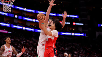 Nov 12, 2025; Houston, Texas, USA; Washington Wizards forward Kyshawn George (18) shoots inside against Houston Rockets center Alperen Sengun (28) during the third quarter at Toyota Center. Mandatory Credit: Erik Williams-Imagn Images