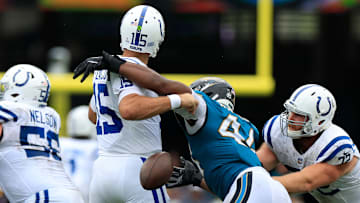 Indianapolis Colts quarterback Joe Flacco (15) fumbles the ball knocked loose by Jacksonville Jaguars defensive end Travon Walker (44) as Indianapolis Colts offensive tackle Braden Smith (72) defends during the second quarter of an NFL football matchup Sunday, Oct. 6, 2024 at EverBank Stadium in Jacksonville, Fla. The Jaguars edged the Colts on a field goal 37-34. [Corey Perrine/Florida Times-Union]