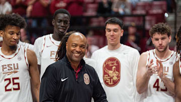 Florida State Seminoles head coach Leonard Hamilton is surrounded by current and former players honoring him during his final home game before retirement. The Florida State Seminoles defeated the Southern Methodist Mustangs 76-69 on Saturday, March 8, 2025.