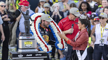 Oct 19, 2025; Talladega, Alabama, USA; Miss Alabama Emma Terry at right presents a victory wreath to NASCAR Cup Series driver Chase Briscoe (19), celebrating his win in victory lane at the YellaWood 500 at Talladega Superspeedway.