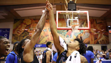 Memphis Tigers' guard Tyrese Hunter and guard PJ Haggerty celebrate after beating the UConn Huskies 99-97 in OT on Nov. 25, 2024.