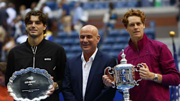 Sep 8, 2024; Flushing, NY, USA; Jannik Sinner (ITA) and Taylor Fritz (USA) pose for a photo alongside tennis legend Andre Agassi after the men’s singles final of the 2024 U.S. Open tennis tournament at USTA Billie Jean King National Tennis Center.