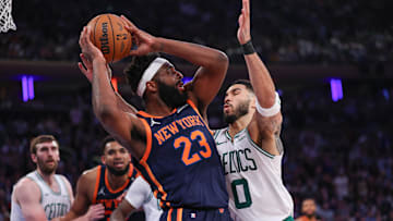 May 12, 2025; New York, New York, USA; New York Knicks center Mitchell Robinson (23) looks to pass after a rebound as Boston Celtics forward Jayson Tatum (0) defends in the first half during game four of the second round for the 2025 NBA Playoffs at Madison Square Garden. Mandatory Credit: Vincent Carchietta-Imagn Images