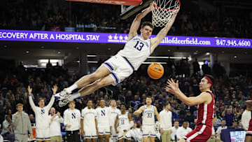 Feb 7, 2024; Evanston, Illinois, USA; Northwestern Wildcats guard Brooks Barnhizer (13) dunks the ball on Nebraska Cornhuskers guard Keisei Tominaga (30) during the second half at Welsh-Ryan Arena. Mandatory Credit: David Banks-Imagn Images