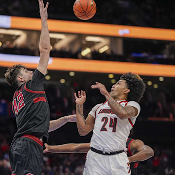 Mar 13, 2025; Charlotte, NC, USA; Stanford Cardinal forward Maxime Raynaud (42) blocks a shot by Louisville Cardinals guard Chucky Hepburn (24) during the second half at Spectrum Center. Mandatory Credit: Jim Dedmon-Imagn Images