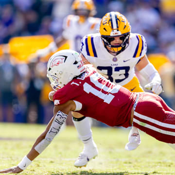 Arkansas Razorbacks quarterback Taylen Green (10) is tackled by LSU Tigers defensive end Jack Pyburn (44) during the first half at Tiger Stadium. 