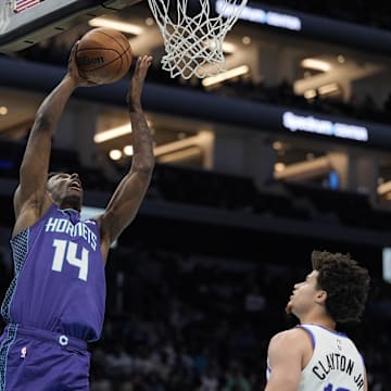 Nov 2, 2025; Charlotte, North Carolina, USA; Charlotte Hornets forward Moussa Diabate (14) makes a lay up against the Utah Jazz during the second quarter at Spectrum Center. Mandatory Credit: Jim Dedmon-Imagn Images