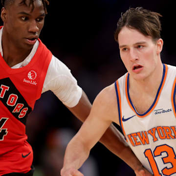 Dec 23, 2024; New York, New York, USA; New York Knicks guard Tyler Kolek (13) controls the ball against Toronto Raptors guard Ja'Kobe Walter (14) during the fourth quarter at Madison Square Garden. Mandatory Credit: Brad Penner-Imagn Images