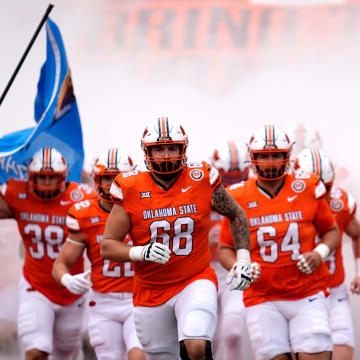 Oklahoma State runs on to the field before the college football game between the Oklahoma State Cowboys and South Dakota State Jackrabbits at Boone Pickens Stadium in Stillwater, Okla., Saturday, Aug., 31, 2024.