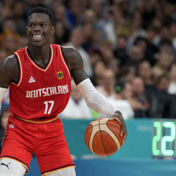 Aug 2, 2024; Villeneuve-d'Ascq, France; Germany point guard Dennis Schroder (17) controls the ball against France point guard Frank Ntilikina (1) in the first half in a men’s group B basketball game during the Paris 2024 Olympic Summer Games at Stade Pierre-Mauroy. Mandatory Credit: John David Mercer-USA TODAY Sports