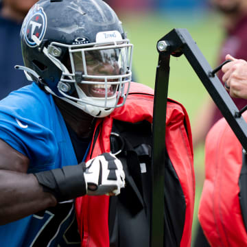 Center Lloyd Cushenberry III hits the sled during drills during the Tennessee Titans mandatory mini-camp at Ascension Saint Thomas Sports Park in Nashville, Tenn., Wednesday, June 5, 2024.