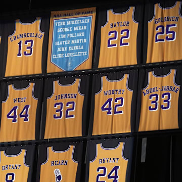 Feb 8, 2021; Los Angeles, California, USA; The retired jerseys of Los Angeles Lakers players Jamaal Wilkes (52), Wilt Chamberlain (13), Elgin Baylor (22), Shaquille O'Neal (34), Jerry West (44), Magic Johnson (32), James Worthy (42), Kareem Abdul-Jabbar (33), Kobe Bryant (8 and 24) and Chick Hearn and the names of Minneapolis Lakers Hall of Fame players Vern Mikkelsen, George Mikan, Jim Pollard, Slater Martin, John Kundla and Clyde Lovellette on display  at Staples Center. Mandatory Credit: