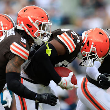 Cleveland Browns defensive end Ogbo Okoronkwo (54), center, carries what he thought would be a turnover with teammates running back Pierre Strong Jr. (20), safety Grant Delpit (9) and safety Rodney McLeod Jr. (12) celebrating along during the second quarter of an NFL football matchup Sunday, Sept. 15, 2024 at EverBank Stadium in Jacksonville, Fla. The Browns defeated the Jaguars 18-13. [Corey Perrine/Florida Times-Union]