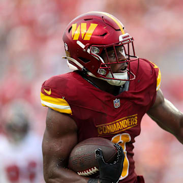 Sep 8, 2024; Tampa, Florida, USA; Washington Commanders running back Brian Robinson Jr. (8) runs with the ball against the Tampa Bay Buccaneers in the third quarter at Raymond James Stadium. Mandatory Credit: Nathan Ray Seebeck-Imagn Images