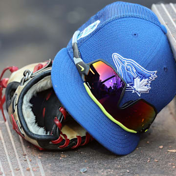 A detail view of Toronto Blue Jays hat and glove against the Detroit Tigers at TD Ballpark.