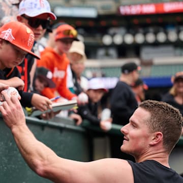May 12, 2024; San Francisco, California, USA; San Francisco Giants infielder Matt Chapman (26) signs an autograph for a fan before the game between the San Francisco Giants and the Cincinnati Reds at Oracle Park