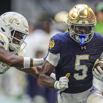 Oct 19, 2024; Atlanta, Georgia, USA; Notre Dame Fighting wide receiver Beaux Collins (5) runs against Georgia Tech Yellow Jackets linebacker Jackson Hamilton (17) during the first half at Mercedes-Benz Stadium.  