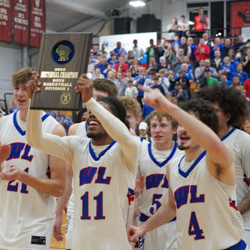 Wisconsin Lutheran Vikings players display the WIAA D1 Sectional 4 plaque to their fans after beating West Allis Central, 72-53 on Saturday, March 15, 2025 at Waukesha South High School. They now face No. 4 Oshkosh North in the first round of the WIAA 2025 State Boys Basketball Tournament.