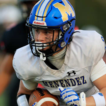 Menendez's Nate Carr (2) rushes for yards during the first quarter of a high school football matchup Monday, Oct. 14, 2024 at Bishop Kenny High School in Jacksonville, Fla. The Bishop Kenny Crusaders held off the Menendez Falcons 17-10. [Corey Perrine/Florida Times-Union]