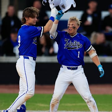 Trinity Christian's Gage Petrutz (1) taps helmets with Trinity Christian's Parker Loew (9) after a solo home run during the third inning of a high school baseball matchup Thursday, March 20, 2025 at Trinity Christian Academy in Jacksonville, Fla. The duo have helped their team move up to No. 7 on our latest rankings and in the semifinals of the Florida Class 2A Playoffs.