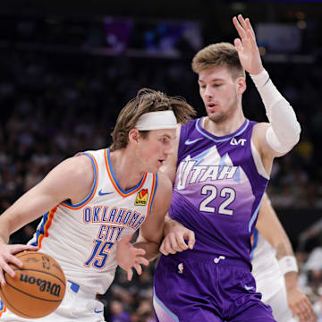 Apr 11, 2025; Salt Lake City, Utah, USA;  Oklahoma City Thunder center Branden Carlson (15) tries to dribble past Utah Jazz forward Kyle Filipowski (22) during the second quarter at Delta Center. Mandatory Credit: Chris Nicoll-Imagn Images