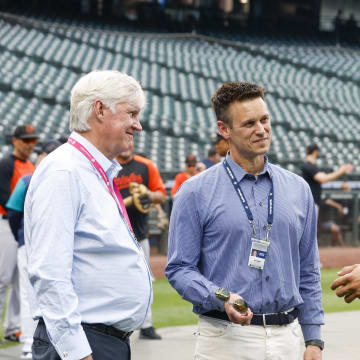 Seattle Mariners center fielder Julio Rodriguez (44) talks with majority owner John Stanton, left, and general manager Jerry Dipoto during batting practice against the Baltimore Orioles at T-Mobile Park in 2023.