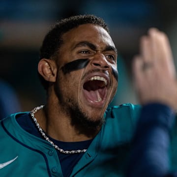 Seattle Mariners centerfielder Julio Rodriguez (44) celebrates in the dugout after scoring a run during the seventh inning against the Oakland Athletics at T-Mobile Park in 2024.