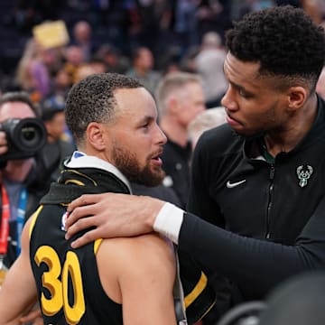 Milwaukee Bucks forward Giannis Antetokounmpo (34) and Golden State Warriors guard Stephen Curry (30).