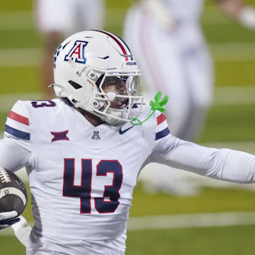 Nov 1, 2025; Boulder, Colorado, USA; Arizona Wildcats defensive back Dalton Johnson (43) returns the ball after an interception in the second quarter against the Colorado Buffaloes at Folsom Field. Mandatory Credit: Ron Chenoy-Imagn Images