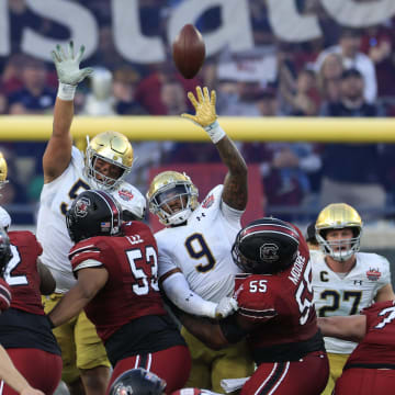 Notre Dame Fighting Irish defensive lineman Rylie Mills (99) defensive lineman Howard Cross III (56) and defensive lineman Justin Ademilola (9) can't stop a field goal from South Carolina Gamecocks place kicker Mitch Jeter (98) during the second quarter of the TaxSlayer Gator Bowl of an NCAA college football game Friday, Dec. 30, 2022 at TIAA Bank Field in Jacksonville.  