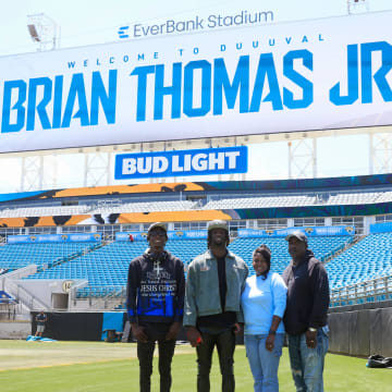 Jacksonville Jaguars wide receiver Brian Thomas Jr., center left, cousin, Leantre Thomas, left, mother, Sondra Thomas, center right, and father, Brian Thomas Sr., pose for a photo before a press conference Friday, April 26, 2024 at EverBank StadiumÕs Miller Electric Center in Jacksonville, Fla. Jacksonville Jaguars selected LSUÕs wide receiver Brian Thomas Jr. as the 23rd overall pick in last nightÕs NFL Draft. [Corey Perrine/Florida Times-Union]