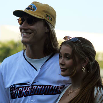 Jaguars quarterback Trevor Lawrence and his wife, Marissa, pose for fans after his ceremonial first pitch before the Jacksonville Jumbo Shrimp's Triple-A baseball home opener against Durham on April 4, 2023. [Clayton Freeman/Florida Times-Union]