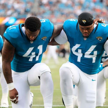 Jacksonville Jaguars defensive end Josh Hines-Allen (41) and defensive end Travon Walker (44) pray before a preseason NFL football game Saturday, Aug. 10, 2024 at EverBank Stadium in Jacksonville, Fla. The Jacksonville Jaguars defeated the Kansas City Chiefs 26-13. [Corey Perrine/Florida Times-Union]