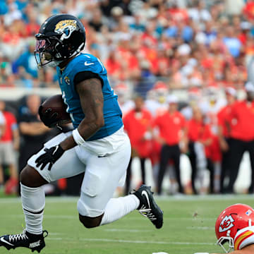 Jacksonville Jaguars running back Travis Etienne Jr. (1) escapes Kansas City Chiefs linebacker Drue Tranquill (23) during the first quarter of a preseason NFL football game Saturday, Aug. 10, 2024 at EverBank Stadium in Jacksonville, Fla. [Corey Perrine/Florida Times-Union]