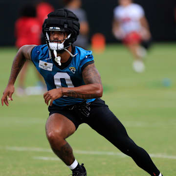 Jacksonville Jaguars wide receiver Gabe Davis (0) runs as assistant wide receivers coach, passing game specialist Tyler Tettleton looks on during a combined NFL football training camp session between the Tampa Bay Buccaneers and Jacksonville Jaguars Thursday, Aug. 15, 2024 at EverBank StadiumÕs Miller Electric Center in Jacksonville, Fla. [Corey Perrine/Florida Times-Union]