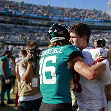 Jacksonville Jaguars quarterback Trevor Lawrence (16) hugs New York Giants quarterback Daniel Jones (8) after the game of a regular season NFL football matchup Sunday, Oct. 23, 2022 at TIAA Bank Field in Jacksonville. The New York Giants defeated the Jacksonville Jaguars 23-17. [Corey Perrine/Florida Times-Union]

Jki 102322 Giants Jags Cp 29
