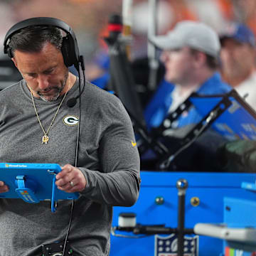 Aug 18, 2024; Denver, Colorado, USA; Green Bay Packers linebackers coach Anthony Campanile looks at a tablet in the second half against the Denver Broncos at Empower Field at Mile High. Mandatory Credit: Ron Chenoy-Imagn Images