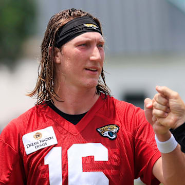Jacksonville Jaguars quarterback Trevor Lawrence (16) fist bumps executive vice president of football operations Tony Boselli during the first organized team activity at Miller Electric Center Monday, May 19, 2025 in Jacksonville, Fla.