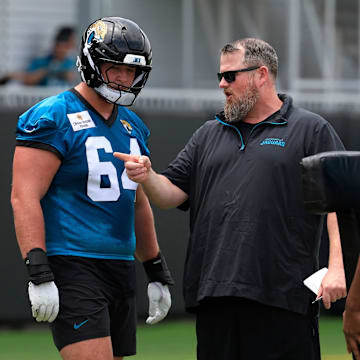 Jacksonville Jaguars guard Wyatt Milum (64) listens to offensive line coach Shaun Sarrett during a rookie minicamp at Miller Electric Center Saturday, May 10, 2025 in Jacksonville, Fla. [Corey Perrine/Florida Times-Union]