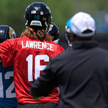 Jacksonville Jaguars quarterback Trevor Lawrence (16) taps wide receiver Travis Hunter (12) on the helmet as wide receiver Cam Camper (17) looks on during the first organized team activity at Miller Electric Center Monday, May 19, 2025 in Jacksonville, Fla.