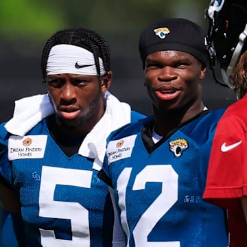 Jacksonville Jaguars wide receiver Travis Hunter (12) talks with quarterback Trevor Lawrence (16) as wide receiver Dyami Brown (5) looks on after an NFL training camp session at the Miller Electric Center, Sunday, Aug. 3, 2025, in Jacksonville, Fla. [Corey Perrine/Florida Times-Union]
