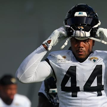 Jacksonville Jaguars defensive end Travon Walker (44) puts on his helmet during an NFL training camp session at the Miller Electric Center, Friday, July 25, 2025, in Jacksonville, Fla. [Corey Perrine/Florida Times-Union]
