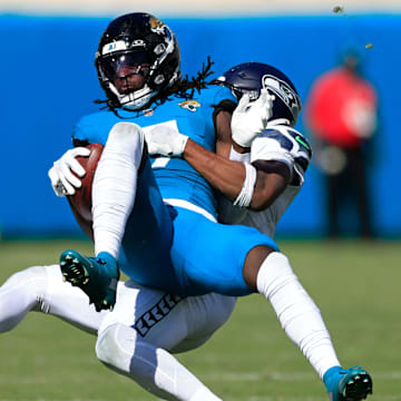 Jacksonville Jaguars wide receiver Brian Thomas Jr. (7) is tackled by Seattle Seahawks safety Nick Emmanwori (3) during the fourth quarter of an NFL football matchup, Sunday, Oct. 12, 2025, at EverBank Stadium in Jacksonville, Fla. The Seahawks defeated the Jaguars 20-12. [Corey Perrine/Florida Times-Union]
