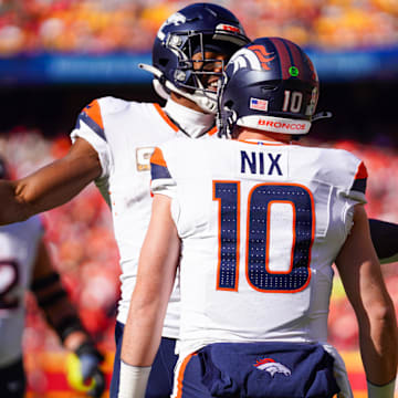 Nov 10, 2024; Kansas City, Missouri, USA; Denver Broncos wide receiver Courtland Sutton (14) celebrates with quarterback Bo Nix (10) after scoring against the Kansas City Chiefs during the first half at GEHA Field at Arrowhead Stadium.