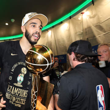 Jun 17, 2024; Boston, Massachusetts, USA; Boston Celtics forward Jayson Tatum (0) holds the Larry O’Brien Championship Trophy after their win against the Dallas Mavericks after game five of the 2024 NBA Finals at TD Garden. Mandatory Credit: Elsa/Pool Photo-USA TODAY Sports