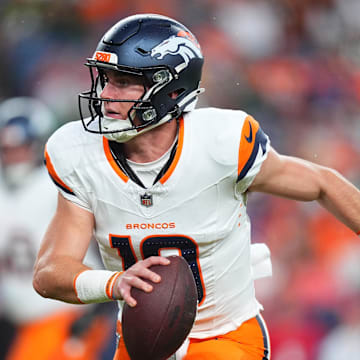 Aug 18, 2024; Denver, Colorado, USA; Denver Broncos quarterback Bo Nix (10) scrambles with the ball in the first quarter against the Green Bay Packers at Empower Field at Mile High.