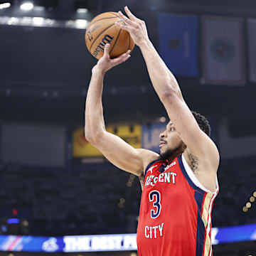 Apr 24, 2024; Oklahoma City, Oklahoma, USA; New Orleans Pelicans guard CJ McCollum (3) shoots a three-point basket against the Oklahoma City Thunder during the second quarter of game two of the first round for the 2024 NBA playoffs at Paycom Center.