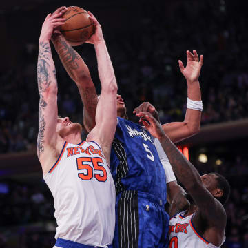 Orlando Magic forward Paolo Banchero (5) rebounds against New York Knicks center Isaiah Hartenstein (55) and forward Julius Randle (30) during the second half at Madison Square Garden.